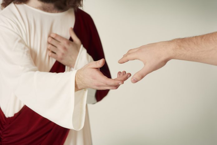 Jesus saving hand reaching for the faithful